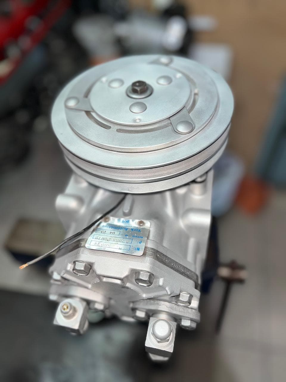 Compresor plateado — taller de Los Calvos Compresores, reparación de compresores de aire acondicionado automotor